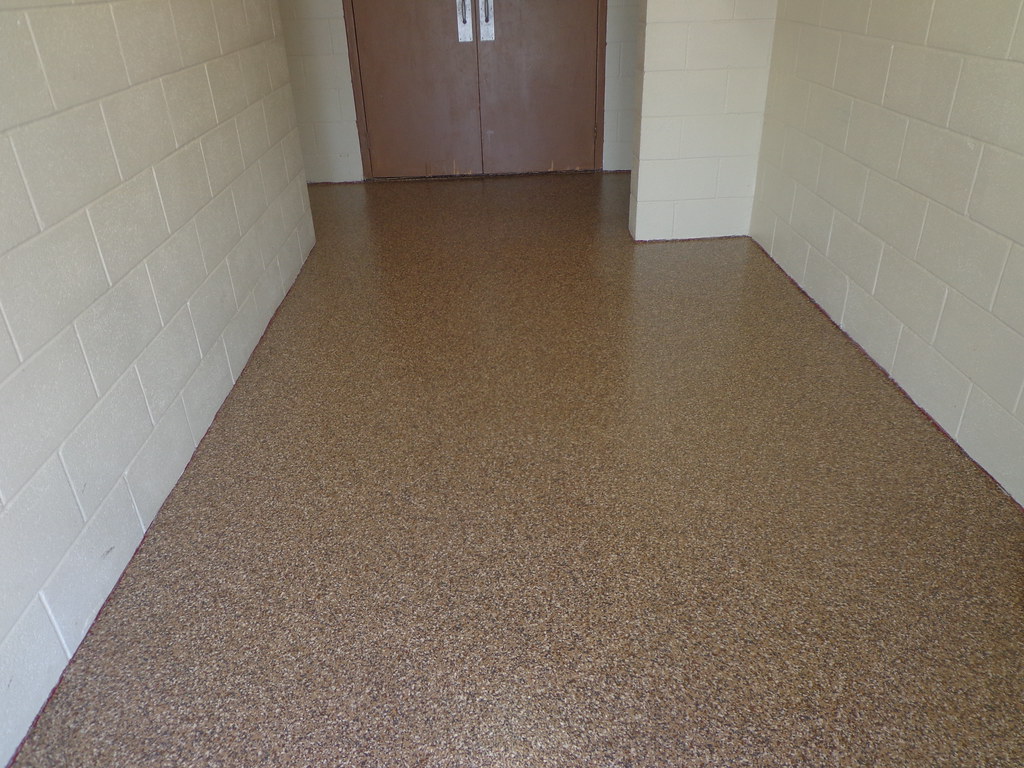 Tan flake epoxy floor coating in a commercial corridor