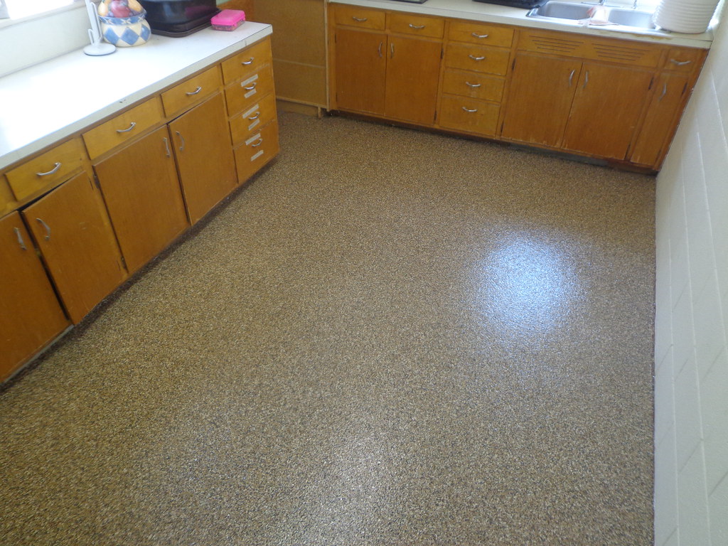 Tan flake epoxy floor in a finished kitchen