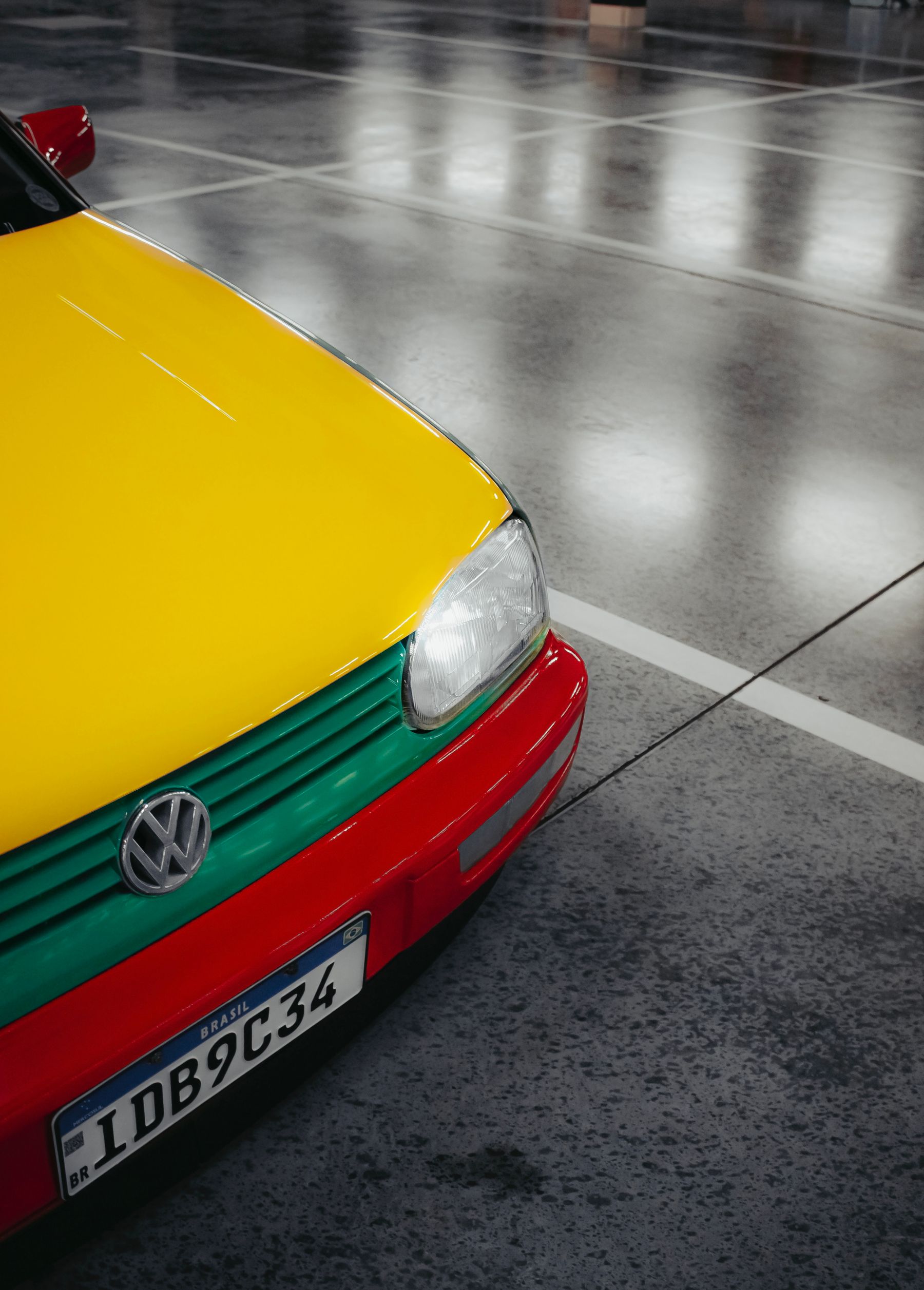 Decorative flake epoxy garage floor beside a parked car